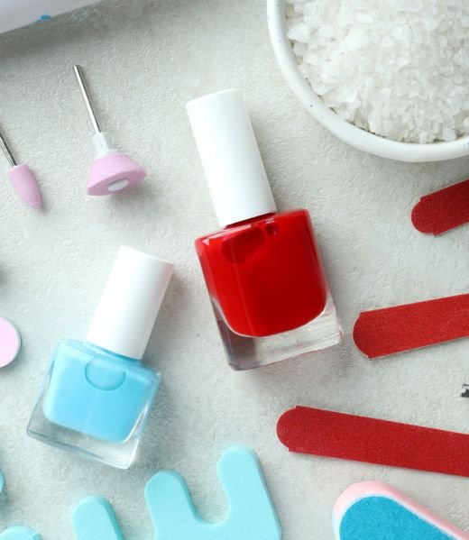 Concept of nail care with manicure accessories on light textured background